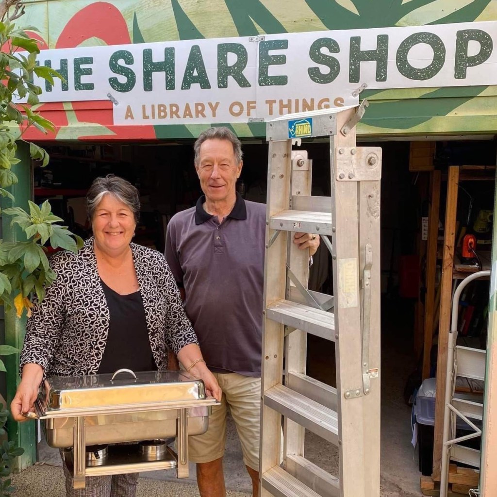 The Share Shop volunteers standing in front of the shop with a ladder and a bain marie